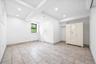 Basement with recessed lighting, light tile patterned floors, and a wall unit AC