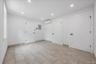Empty room featuring recessed lighting, a wall mounted air conditioner, and electric panel