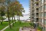 Surrounding community with a lawn and a water view