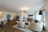 Living area featuring a chandelier and baseboards