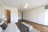 Bedroom with two closets and baseboards