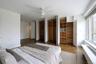 Bedroom with a ceiling fan and multiple closets