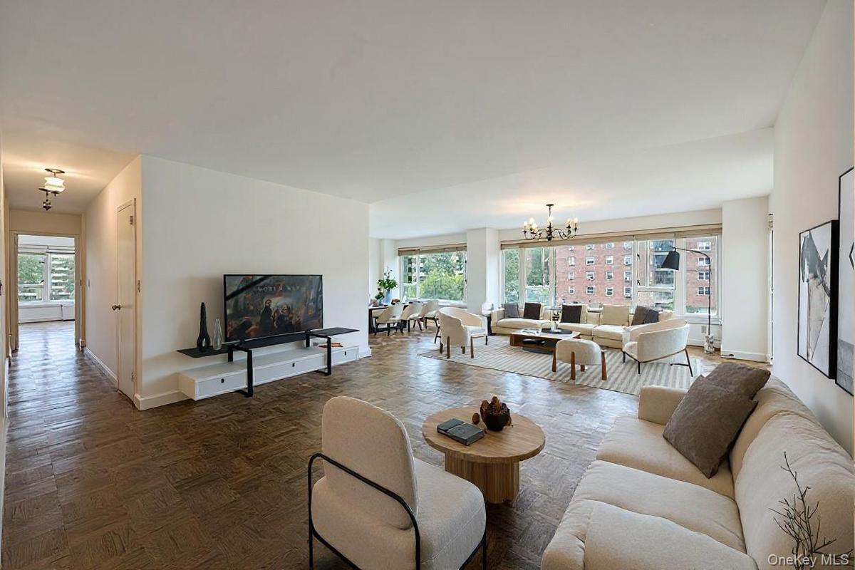 Living area with healthy amount of natural light and a chandelier