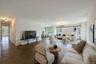Living area with healthy amount of natural light and a chandelier