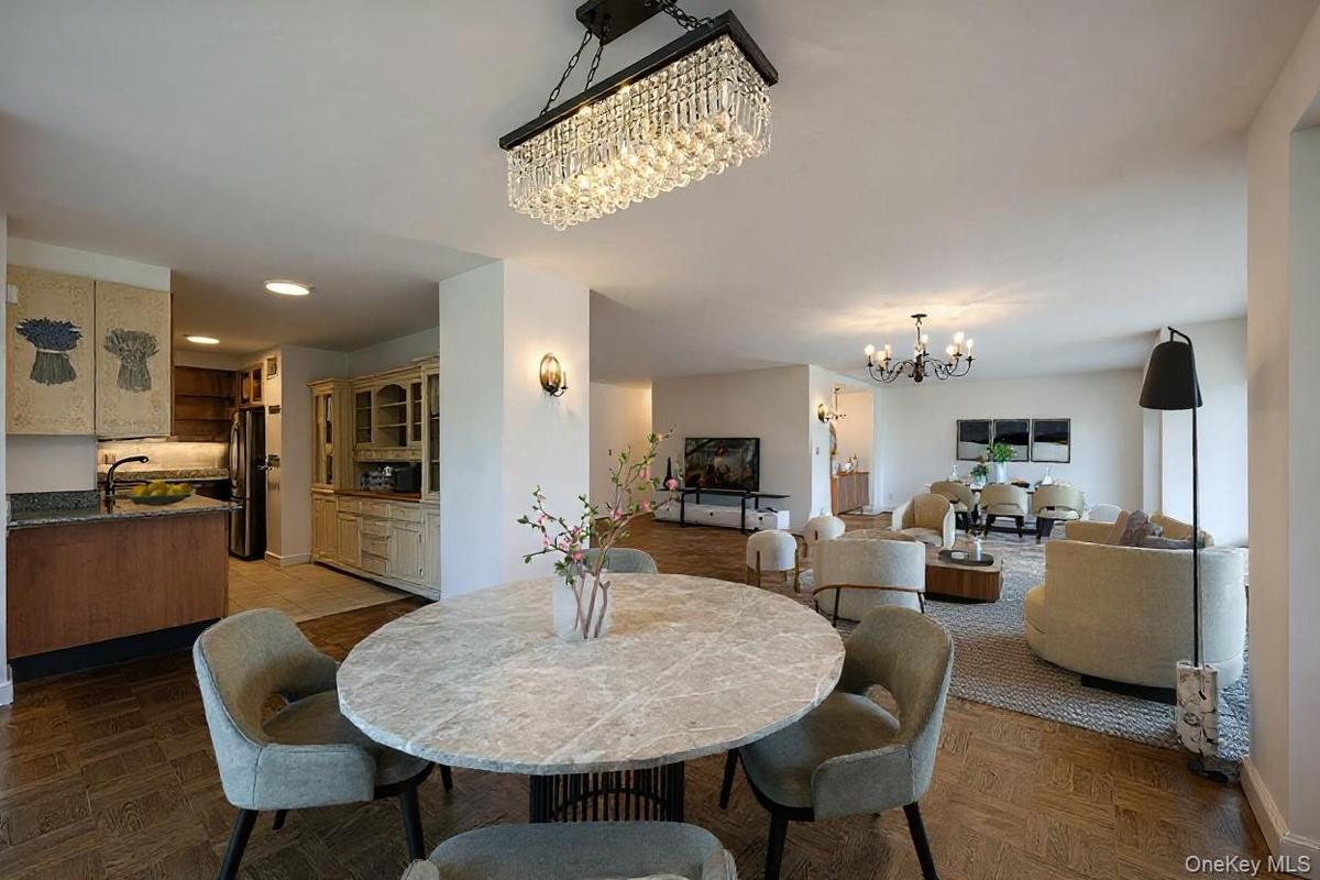 Dining space with a chandelier and recessed lighting