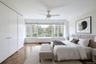 Bedroom featuring radiator heating unit and ceiling fan