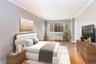 Bedroom with light wood-style flooring and crown molding