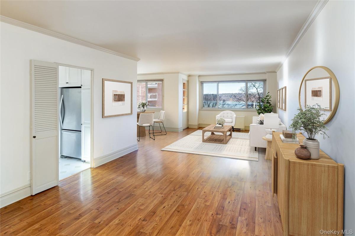 Living room featuring light wood-style floors and ornamental molding