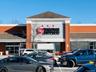 View of commercial property with uncovered parking