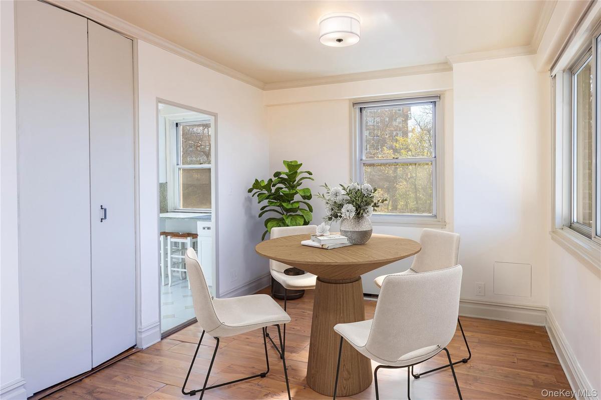 Dining room featuring light wood finished floors and ornamental molding