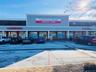 View of commercial property with uncovered parking