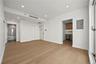 Unfurnished bedroom featuring connected bathroom, light wood finished floors, recessed lighting, and electric panel