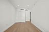 Unfurnished bedroom with light wood-type flooring, recessed lighting, and a closet