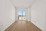 Empty room with light wood finished floors and recessed lighting