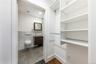 Bathroom with vanity, tile walls, wainscoting, and recessed lighting