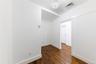 Unfurnished room featuring dark wood-style floors and baseboards