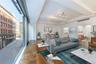 Living room featuring wood finished floors and beamed ceiling