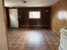 Spare room with wood walls and a baseboard heating unit