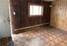 Empty room with a baseboard radiator and wooden walls
