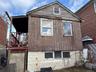Back of house featuring a balcony and stairway