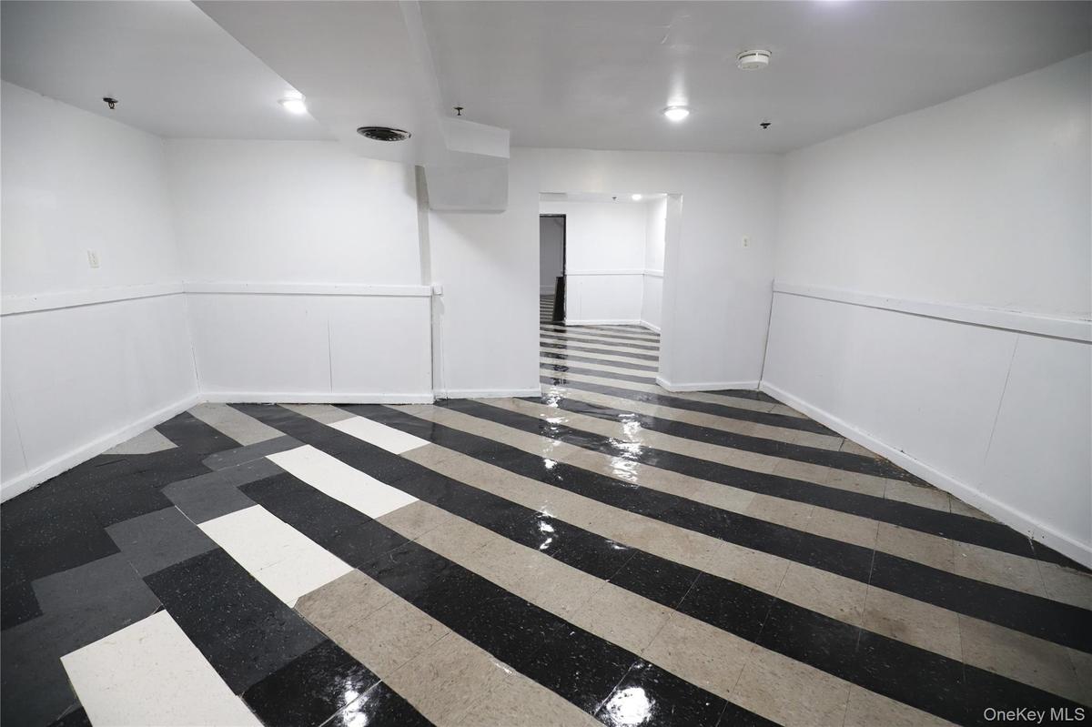 Empty room featuring baseboards