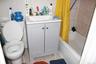 Bathroom featuring tile patterned flooring, shower / bath combo with shower curtain, vanity, and tile walls