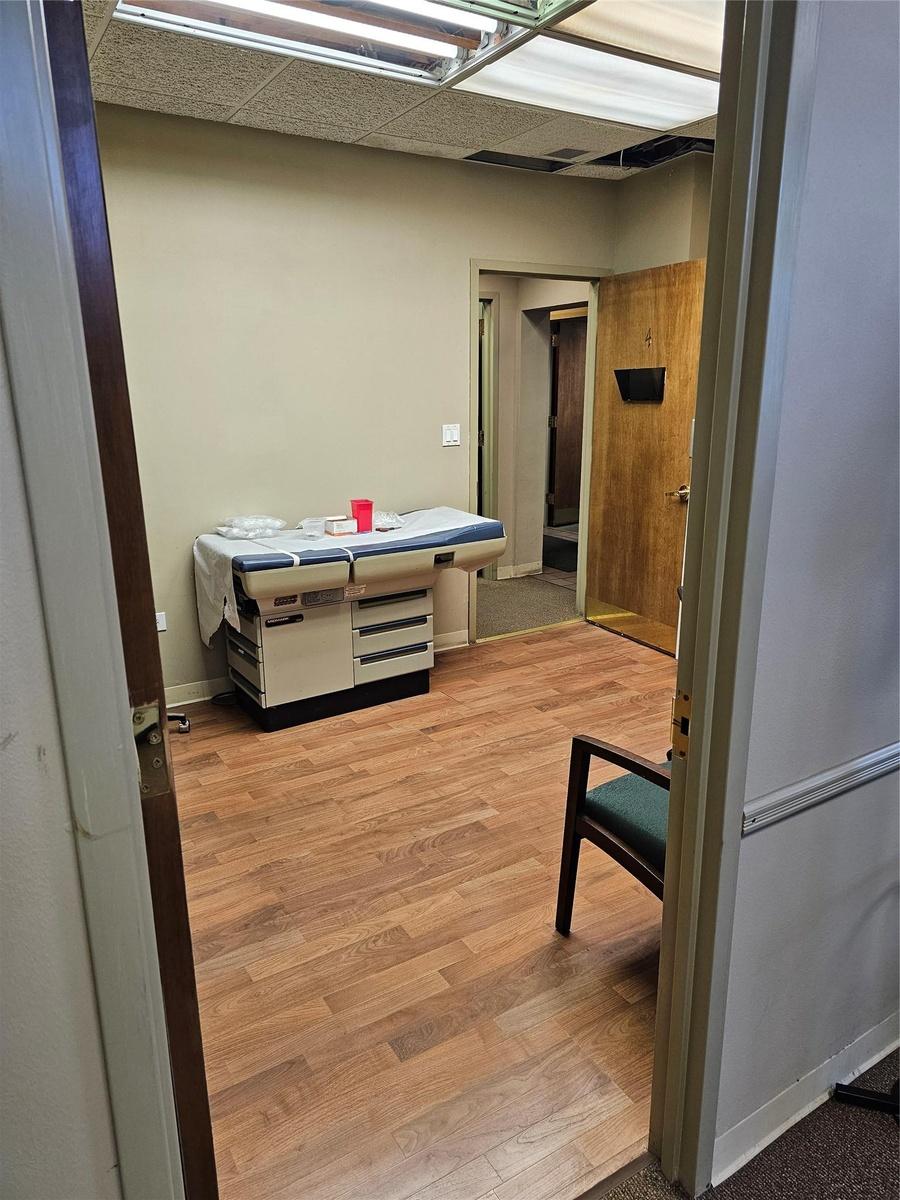Hall with light wood-style flooring and baseboards