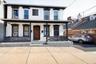 View of front of house featuring covered porch and brick siding