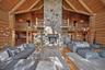 The great room's massive stone fireplace with lots of room for family and guests to relax and enjoy this retreat