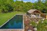 Dynamic entertaining pavilion and gorgeous  65 x 20 gunite infinity pool with waterfall
