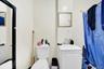 Bathroom with a shower with shower curtain and vanity