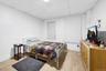 Bedroom featuring a paneled ceiling and light wood-style flooring