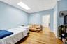Bedroom featuring a drop ceiling and wood finished floors