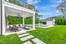 View of grassy yard with an outdoor pool, an outdoor structure, a patio area, an outdoor hangout area, and ceiling fan