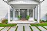 Doorway to property featuring covered porch and board and batten siding