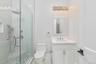Bathroom featuring vanity and a shower stall