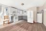 Eat-in Kitchen with gray cabinetry, white appliances, backsplash, light countertops, and white cabinets