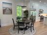 Dining area featuring light wood-style floors, ornamental molding, a chandelier, and recessed lighting