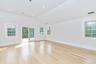 Unfurnished room with light wood-style flooring, vaulted ceiling, and healthy amount of natural light