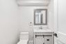 Half bath featuring vanity and toilet