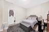 Bedroom with light wood-type flooring and a baseboard radiator