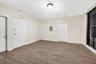 Unfurnished room with wood finished floors and electric panel