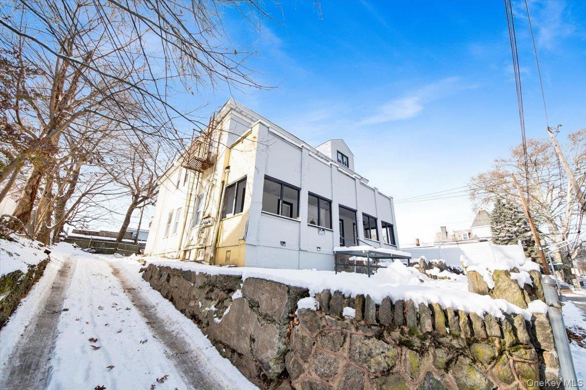 View of snowy exterior with stucco siding