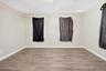 Unfurnished room with light wood-style flooring and baseboards