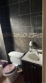 Bathroom featuring tile walls, vanity, and tile patterned floors