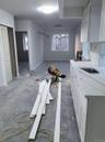 Kitchen with white cabinetry and light stone countertops