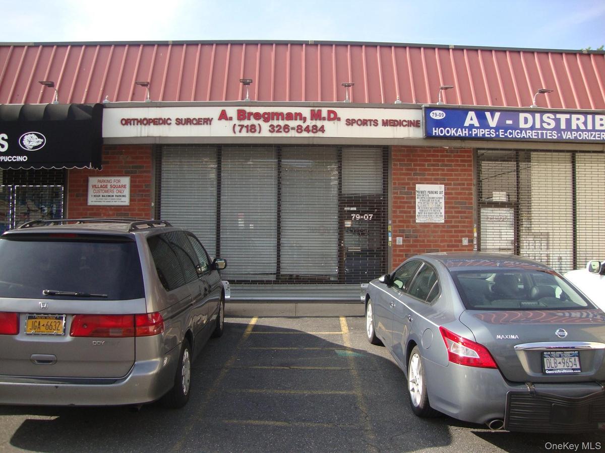 View of commercial location featuring uncovered parking