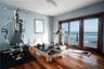 Workout room featuring a water view and hardwood / wood-style floors