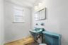 Half bathroom featuring toilet and baseboards