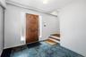 Foyer entrance featuring baseboards and stairway